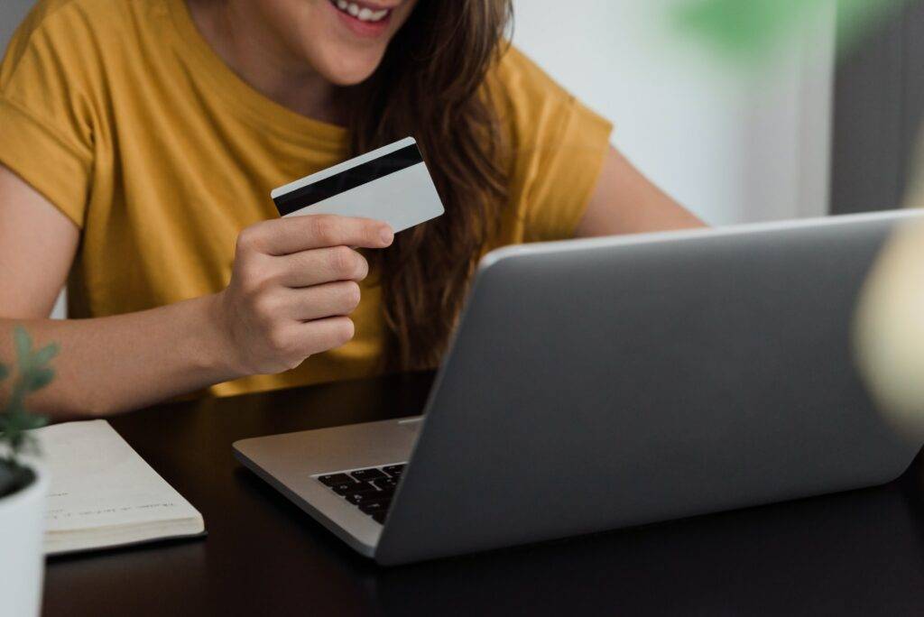 Happy young woman shopping online with credit card - E commerce technology trend concept